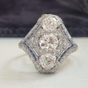 Edwardian Art Deco diamond dinner ring north to south panel dress ring platinum 1910 to 1920 blue sapphires to the side antique old cut diamonds