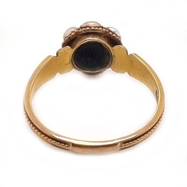 Georgian Antique Emerald and Pearl Cluster Ring, emerald surrounded by pearls in timeless floral cluster design in yellow gold accented with scrolled shoulders and gold granule detailing and locket compartment to reverse