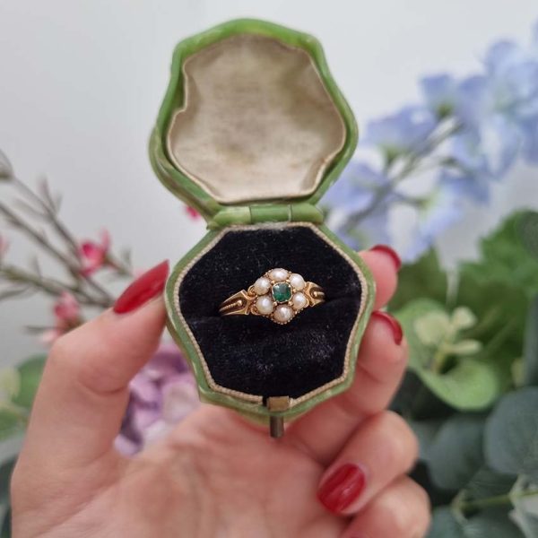 Georgian Antique Emerald and Pearl Cluster Ring, emerald surrounded by pearls in timeless floral cluster design in yellow gold accented with scrolled shoulders and gold granule detailing and locket compartment to reverse