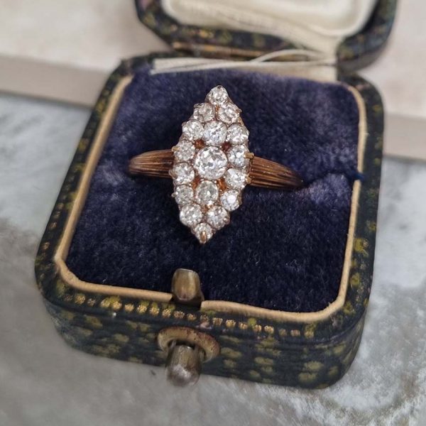 Victorian Antique Old Cut Diamond Navette Cluster Ring, composed of old mine-cut diamond arranged in an eye-catching navette shaped cluster in silver upon yellow gold. Circa 1860.