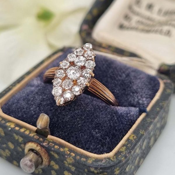 Victorian Antique Old Cut Diamond Navette Cluster Ring, composed of old mine-cut diamond arranged in an eye-catching navette shaped cluster in silver upon yellow gold. Circa 1860.