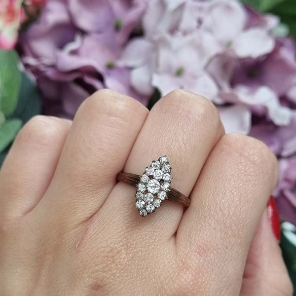 Victorian Antique Old Cut Diamond Navette Cluster Ring, composed of old mine-cut diamond arranged in an eye-catching navette shaped cluster in silver upon yellow gold. Circa 1860.