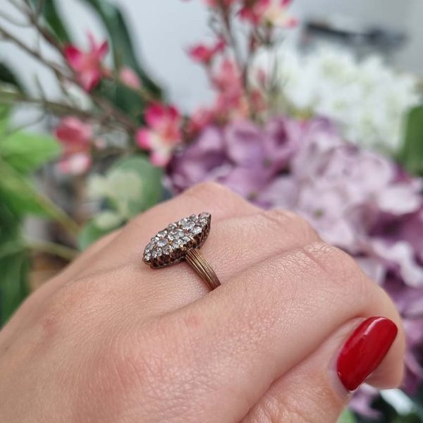 Victorian Antique Old Cut Diamond Navette Cluster Ring, composed of old mine-cut diamond arranged in an eye-catching navette shaped cluster in silver upon yellow gold. Circa 1860.