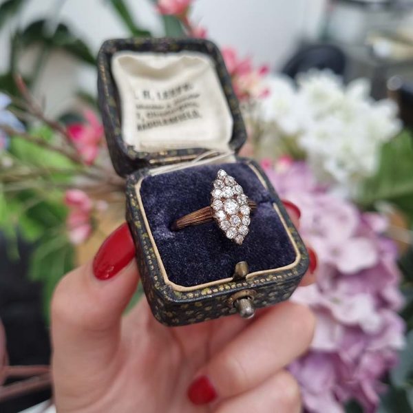 Victorian Antique Old Cut Diamond Navette Cluster Ring, composed of old mine-cut diamond arranged in an eye-catching navette shaped cluster in silver upon yellow gold. Circa 1860.