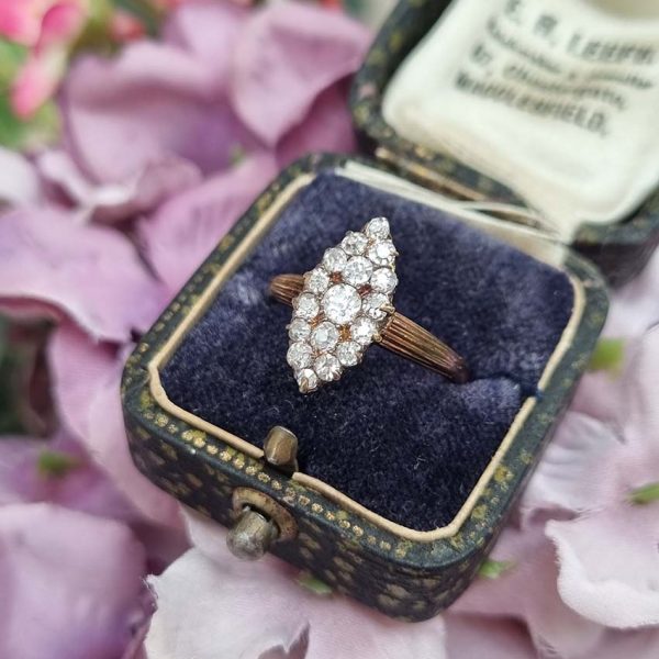 Victorian Antique Old Cut Diamond Navette Cluster Ring, composed of old mine-cut diamond arranged in an eye-catching navette shaped cluster in silver upon yellow gold. Circa 1860.