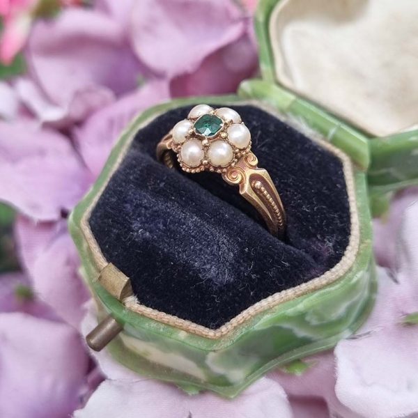 Georgian Antique Emerald and Pearl Cluster Ring, emerald surrounded by pearls in timeless floral cluster design in yellow gold accented with scrolled shoulders and gold granule detailing and locket compartment to reverse