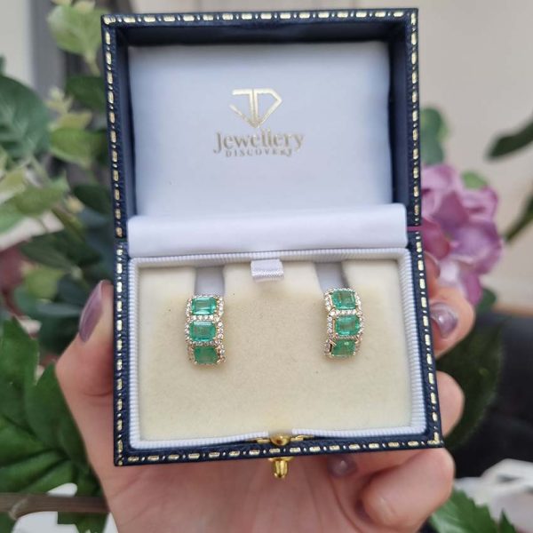 3.50ct Emerald and Diamond Cluster Half Hoop Huggie Earrings in 18ct Yellow Gold, three emerald-cut emeralds set horizontally in a line surrounded by sparkling diamonds