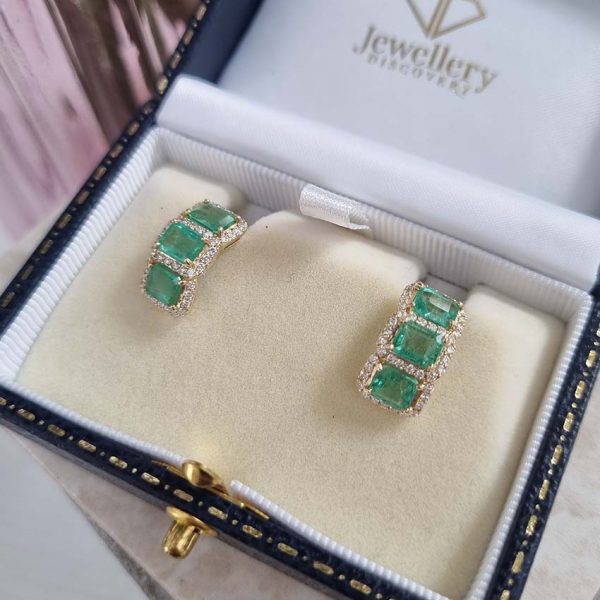 3.50ct Emerald and Diamond Cluster Half Hoop Huggie Earrings in 18ct Yellow Gold, three emerald-cut emeralds set horizontally in a line surrounded by sparkling diamonds