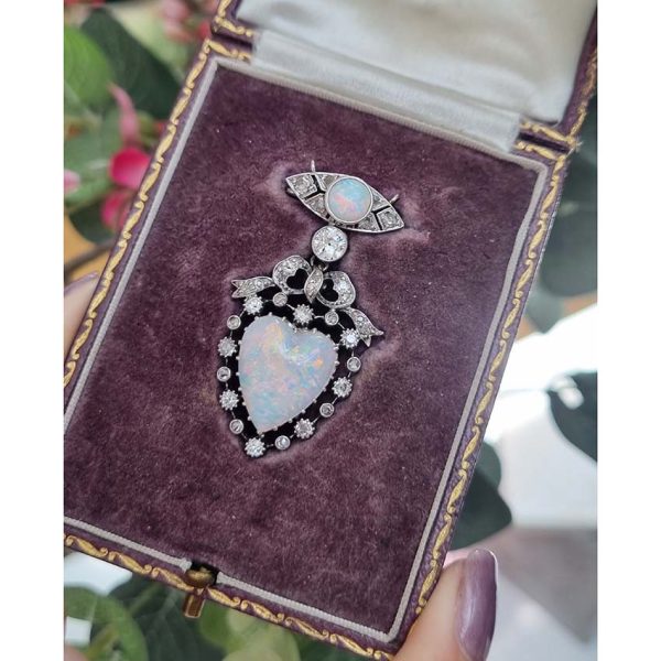 Edwardian Belle Epoque Antique Heart Opal and Diamond Pendant Brooch, heart shaped cabochon opal surrounded by diamonds topped with diamond bow suspended from diamond navette with central round cabochon opal with central old mine-cut diamond link connecting the two parts. Presented in fitted antique box