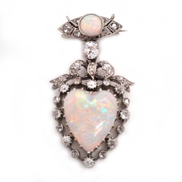 Edwardian Belle Epoque Antique Heart Opal and Diamond Pendant Brooch, heart shaped cabochon opal surrounded by diamonds topped with diamond bow suspended from diamond navette with central round cabochon opal with central old mine-cut diamond link connecting the two parts. Presented in fitted antique box
