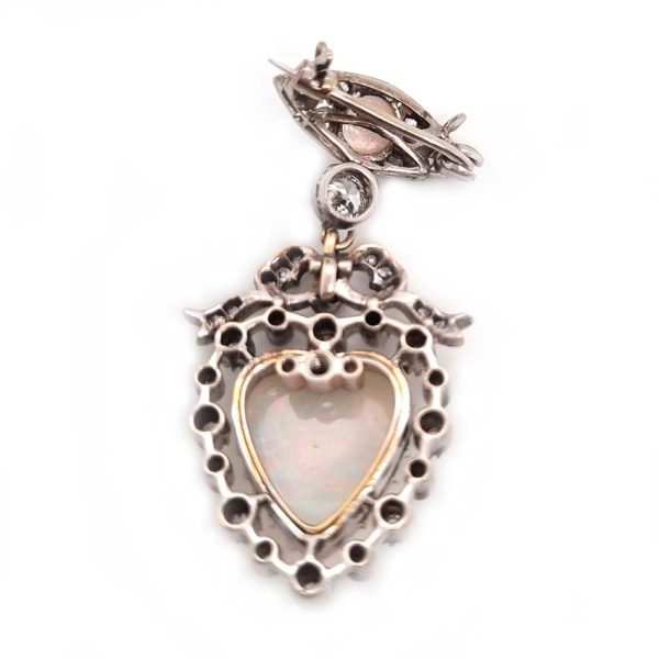 Edwardian Belle Epoque Antique Heart Opal and Diamond Pendant Brooch, heart shaped cabochon opal surrounded by diamonds topped with diamond bow suspended from diamond navette with central round cabochon opal with central old mine-cut diamond link connecting the two parts. Presented in fitted antique box