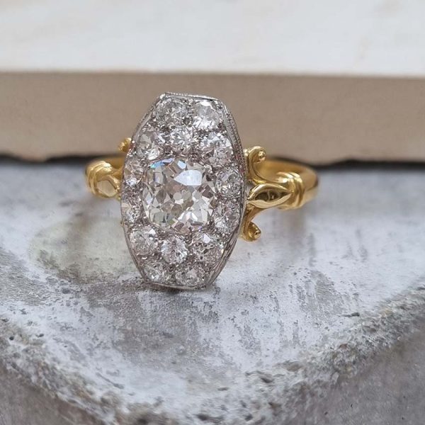 Antique Cushion Old Cut Diamond Cluster Plaque Tablet Ring, 1.08ct cushion-shaped old-cut diamond surrounded by 1.23cts old mine-cut diamonds in platinum to 18ct yellow gold, 2.31 carat total