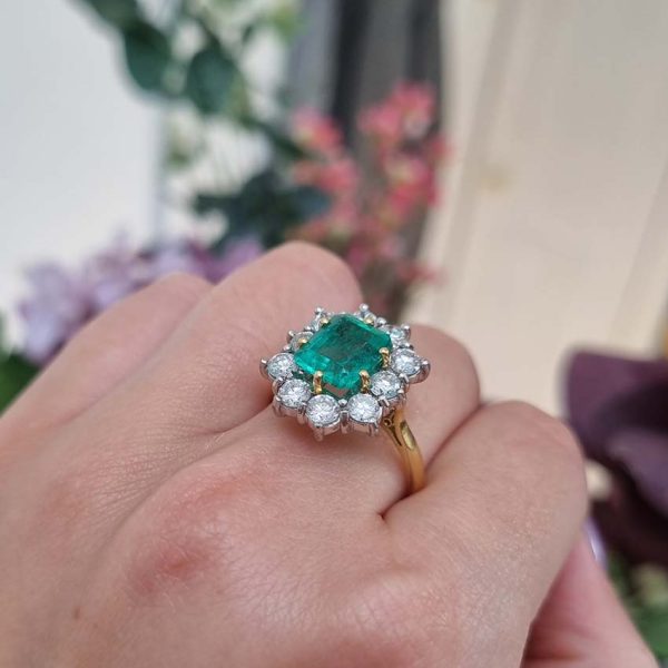 Vintage 2.91ct Emerald and Diamond Cluster Engagement Ring, 2.91ct emerald-cut emerald surrounded by 1.50 carats of sparkling round brilliant-cut diamonds in 18ct yellow gold