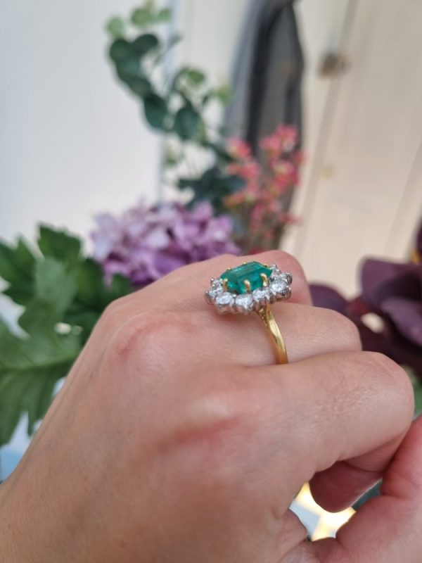 Vintage 2.91ct Emerald and Diamond Cluster Engagement Ring, 2.91ct emerald-cut emerald surrounded by 1.50 carats of sparkling round brilliant-cut diamonds in 18ct yellow gold