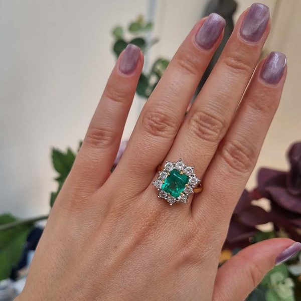 Vintage 2.91ct Emerald and Diamond Cluster Engagement Ring, 2.91ct emerald-cut emerald surrounded by 1.50 carats of sparkling round brilliant-cut diamonds in 18ct yellow gold