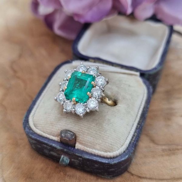 Vintage 2.91ct Emerald and Diamond Cluster Engagement Ring, 2.91ct emerald-cut emerald surrounded by 1.50 carats of sparkling round brilliant-cut diamonds in 18ct yellow gold