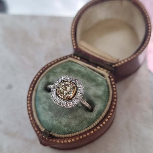 Antique 1.17ct Old Mine Cut Yellow Diamond Cluster Engagement Ring in Platinum, 1.17ct old mine-cut yellow diamond surrounded by halo of white diamonds
