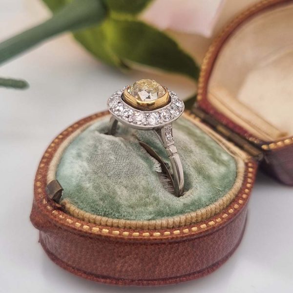 Antique 1.17ct Old Mine Cut Yellow Diamond Cluster Engagement Ring in Platinum, 1.17ct old mine-cut yellow diamond surrounded by halo of white diamonds