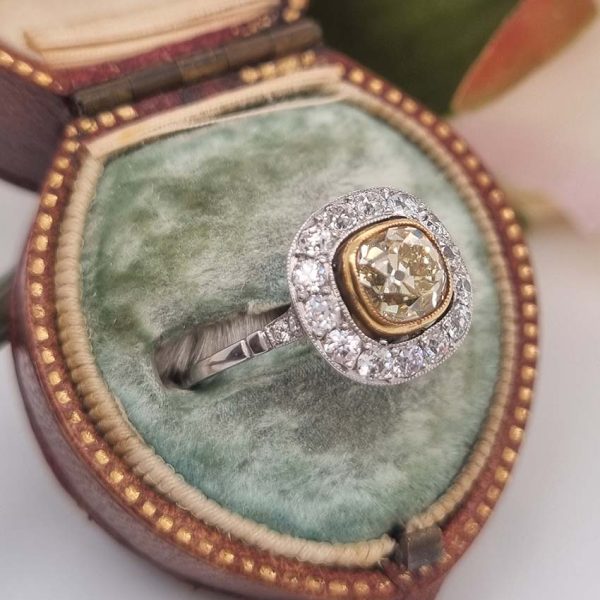 Antique 1.17ct Old Mine Cut Yellow Diamond Cluster Engagement Ring in Platinum, 1.17ct old mine-cut yellow diamond surrounded by halo of white diamonds