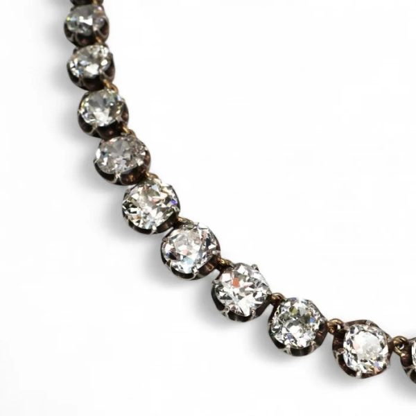Victorian Antique 40cts Old Cut Diamond Line Riviere Necklace, 54 old-cut diamonds totalling 40 carats in silver-upon-gold crown claw settings. Late 19th century Circa 1880