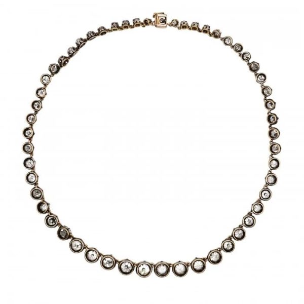 Victorian Antique 40cts Old Cut Diamond Line Riviere Necklace, 54 old-cut diamonds totalling 40 carats in silver-upon-gold crown claw settings. Late 19th century Circa 1880