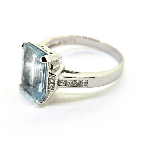 3ct Aquamarine and Princess Cut Diamond Engagement Ring, 3.02ct emerald-cut aquamarine flanked by square princess-cut diamonds in 18ct white gold