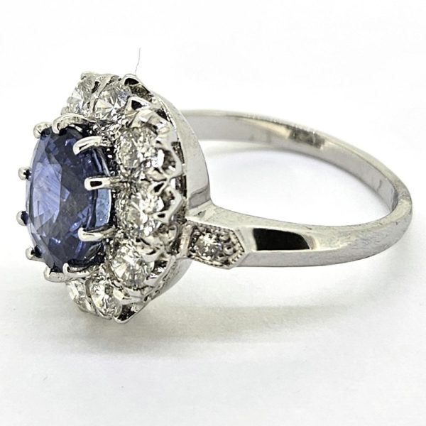 3.25ct Sapphire and Diamond Cluster Engagement Ring in Platinum, 3.25ct blue sapphire surrounded by 1.35 carats of sparkling brilliant-cut diamonds