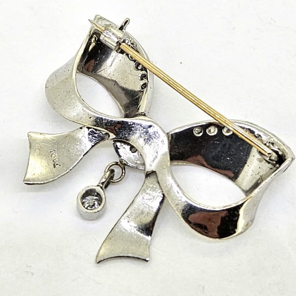 Diamond Set 18ct Gold Bow Brooch, 18ct white gold brooch in the form of a bow, accented with sparkling diamonds