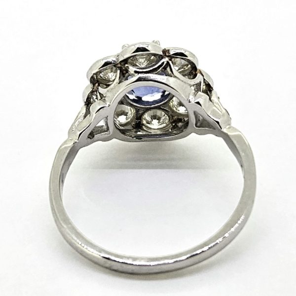 1.60ct Sapphire and Diamond Floral Cluster Engagement Ring in Platinum, 1.60ct oval blue sapphire surrounded by 1.40cts brilliant-cut diamonds in timeless flower cluster design