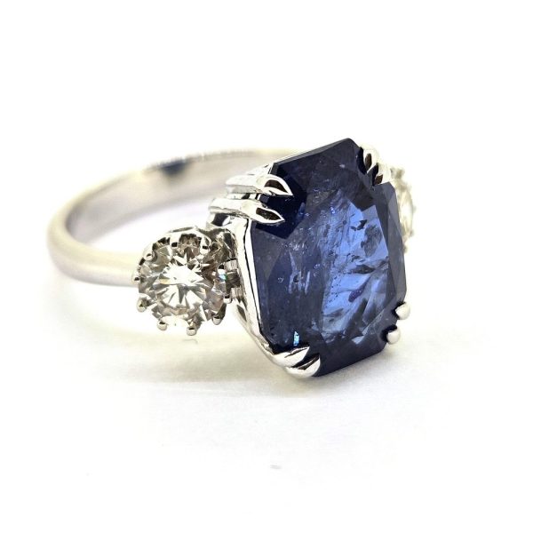 6.71ct Sapphire and Diamond Trilogy Three Stone Engagement Ring in 18ct White Gold, 6.71ct oval cushion-shaped blue sapphire flanked by 0.82cts sparkling brilliant diamonds