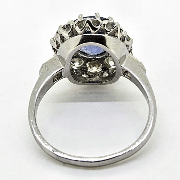 3.25ct Sapphire and Diamond Cluster Engagement Ring in Platinum, 3.25ct blue sapphire surrounded by 1.35 carats of sparkling brilliant-cut diamonds