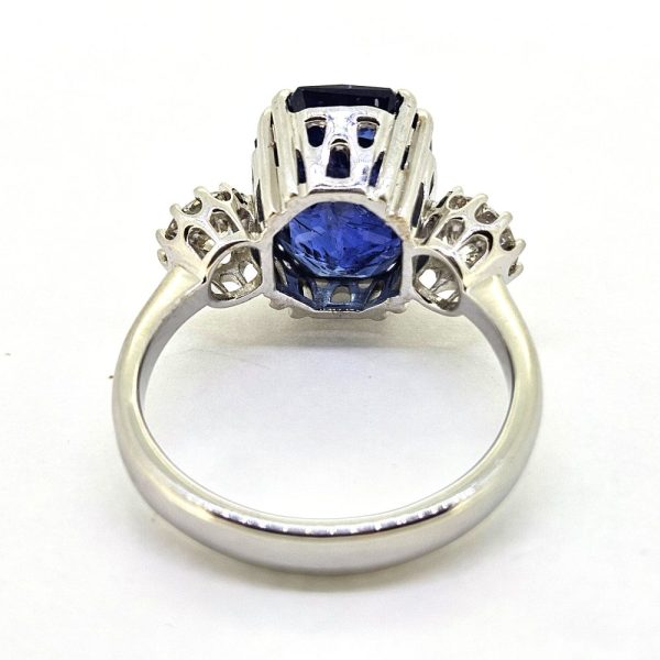 6.71ct Sapphire and Diamond Trilogy Three Stone Engagement Ring in 18ct White Gold, 6.71ct oval cushion-shaped blue sapphire flanked by 0.82cts sparkling brilliant diamonds