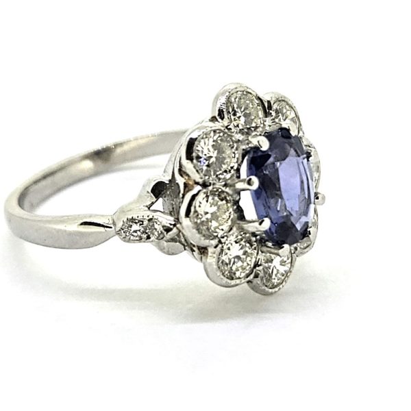 1.60ct Sapphire and Diamond Floral Cluster Engagement Ring in Platinum, 1.60ct oval blue sapphire surrounded by 1.40cts brilliant-cut diamonds in timeless flower cluster design