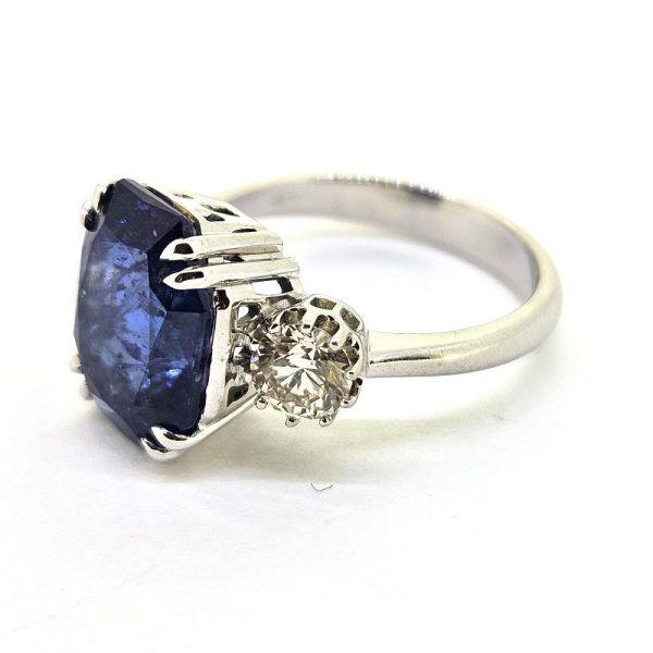 6.71ct Sapphire and Diamond Trilogy Three Stone Engagement Ring in 18ct White Gold, 6.71ct oval cushion-shaped blue sapphire flanked by 0.82cts sparkling brilliant diamonds