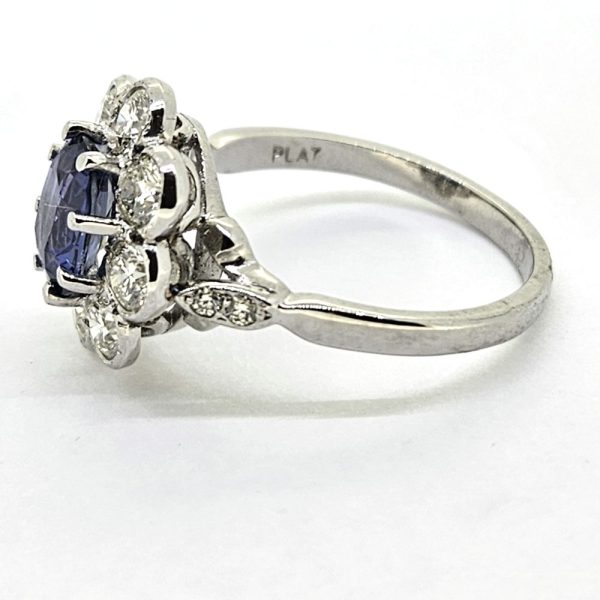 1.60ct Sapphire and Diamond Floral Cluster Engagement Ring in Platinum, 1.60ct oval blue sapphire surrounded by 1.40cts brilliant-cut diamonds in timeless flower cluster design