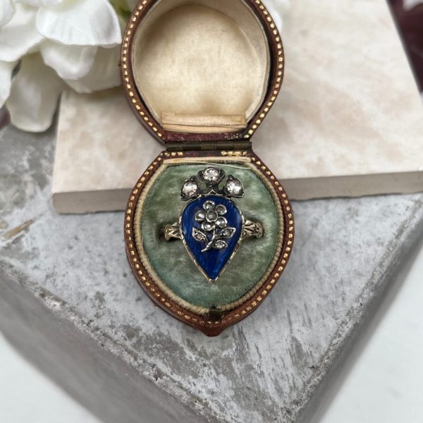 Antique late Victorian ring with blue enamel and diamond flower design.