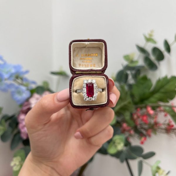 Natural no heat pigeon blood ruby and diamond cluster ring in platinum with diamond halo and GRS certification.