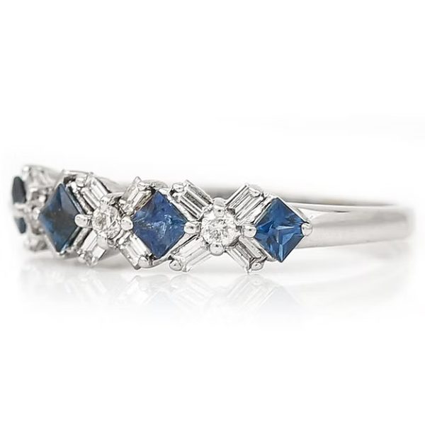 Contemporary 18ct white gold half eternity ring with square-cut blue sapphires and baguette and brilliant-cut diamonds in a geometric design.