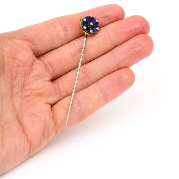 Antique Victorian 15ct gold stick pin featuring dark blue enamel and rose-cut diamonds in a floral ribbon design, circa 1890