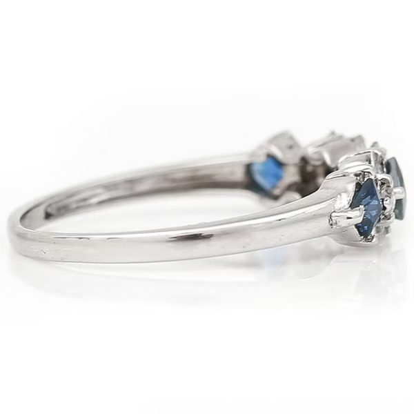 Contemporary 18ct white gold half eternity ring with square-cut blue sapphires and baguette and brilliant-cut diamonds in a geometric design.