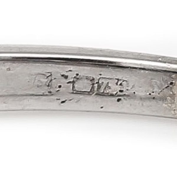 Contemporary 18ct white gold half eternity ring with square-cut blue sapphires and baguette and brilliant-cut diamonds in a geometric design.