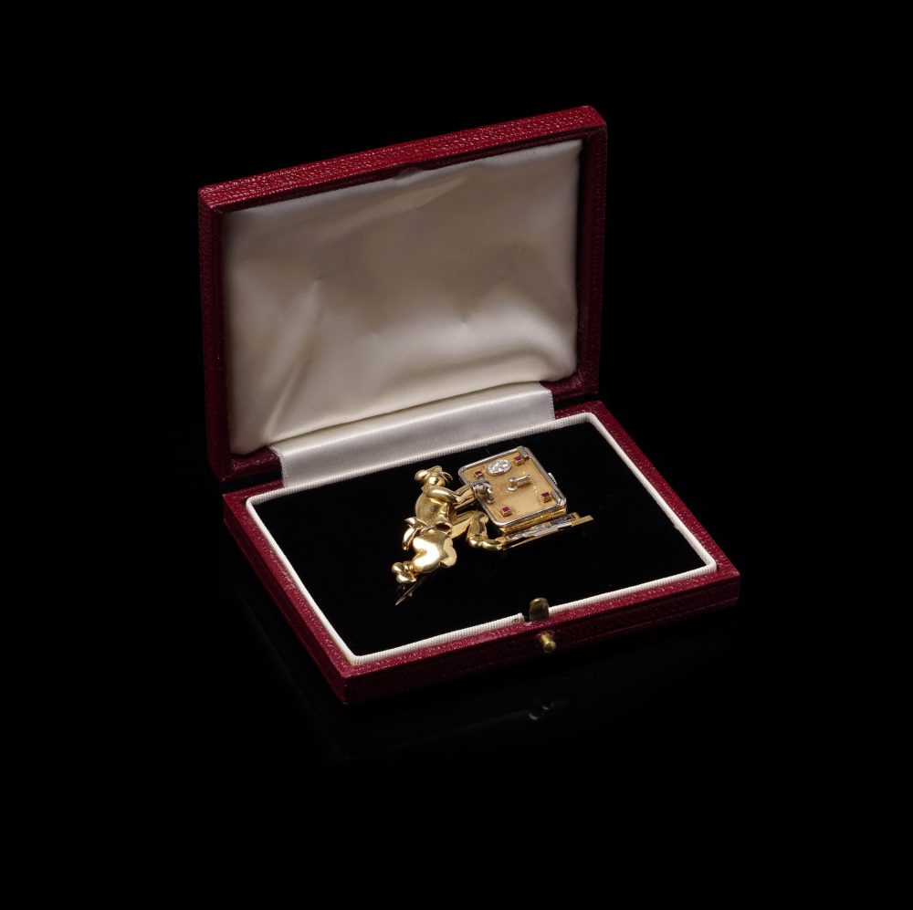 Vintage gold brooch/watch set with gemstones.