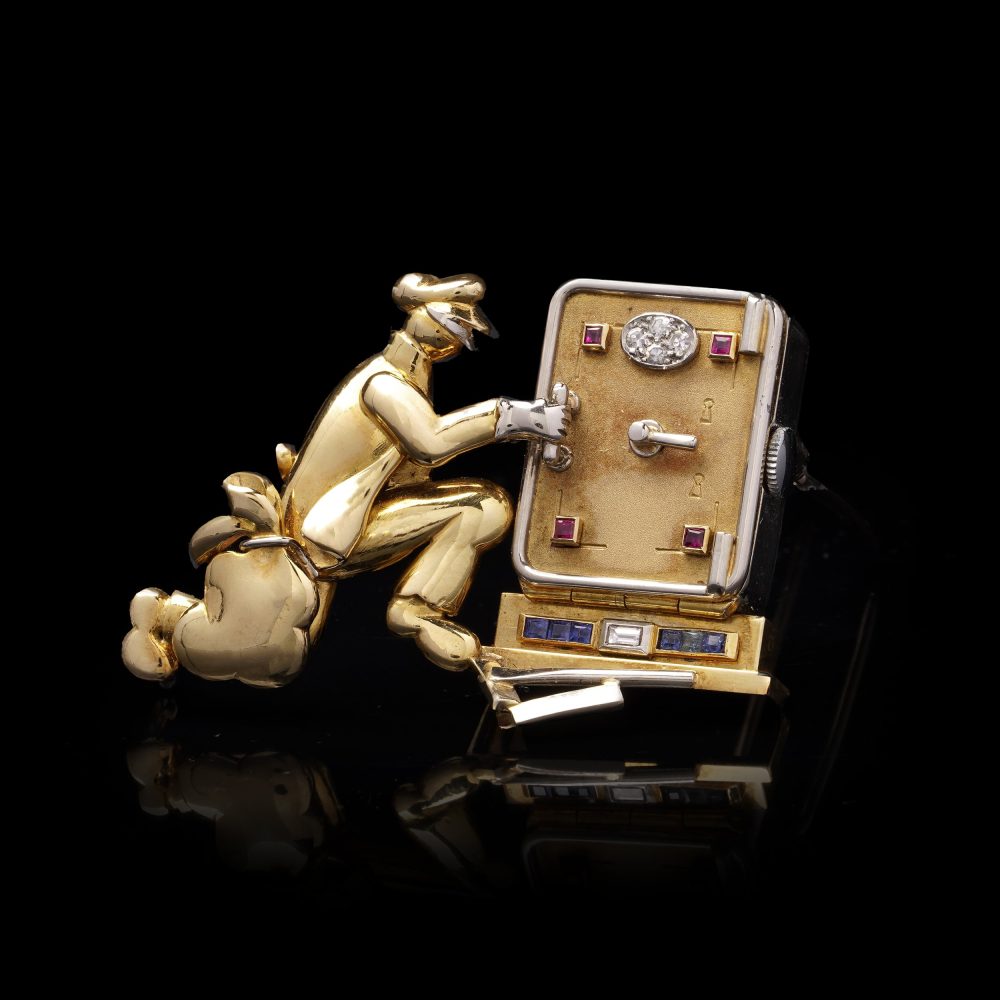 Vintage gold brooch/watch set with gemstones.