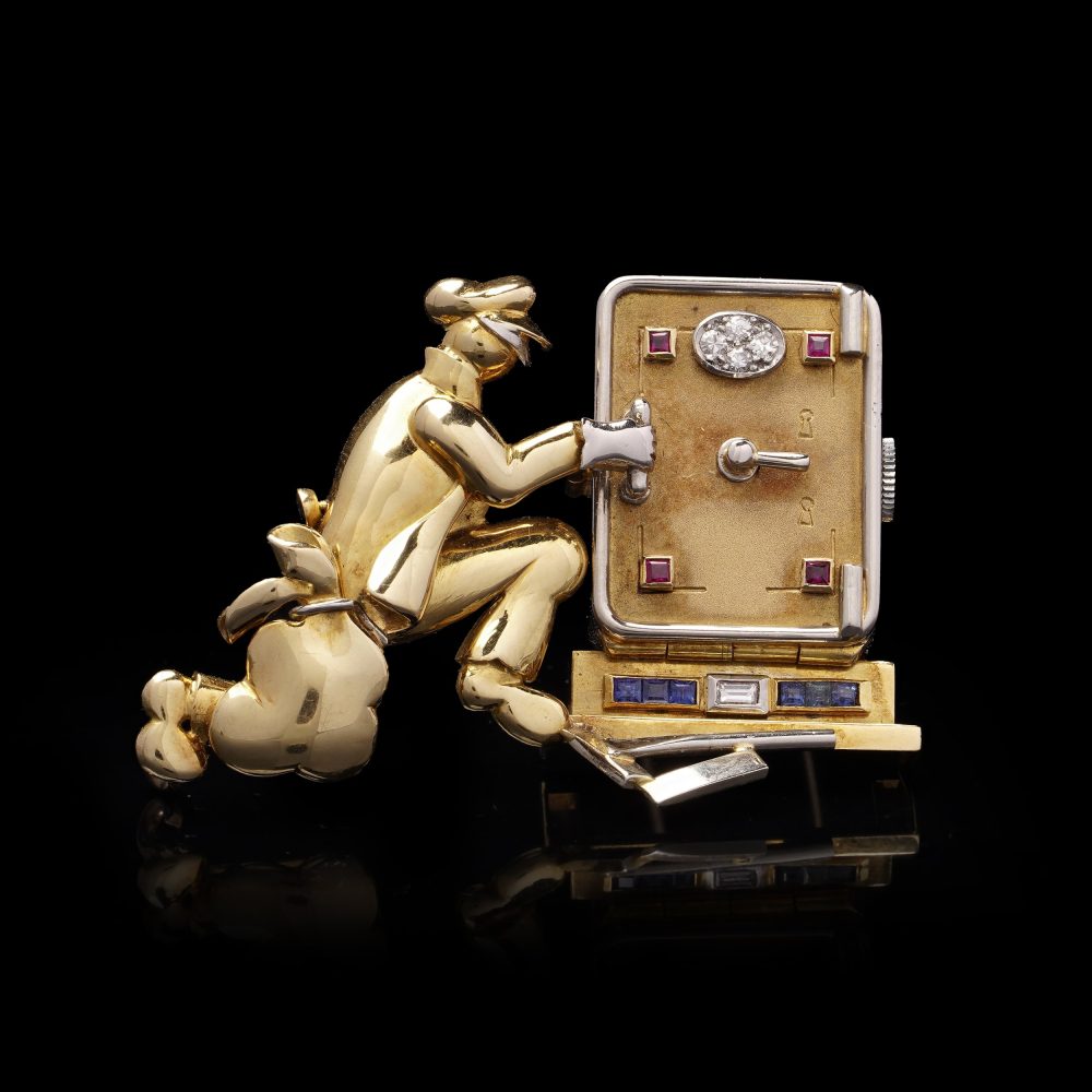 Vintage gold brooch/watch set with gemstones.