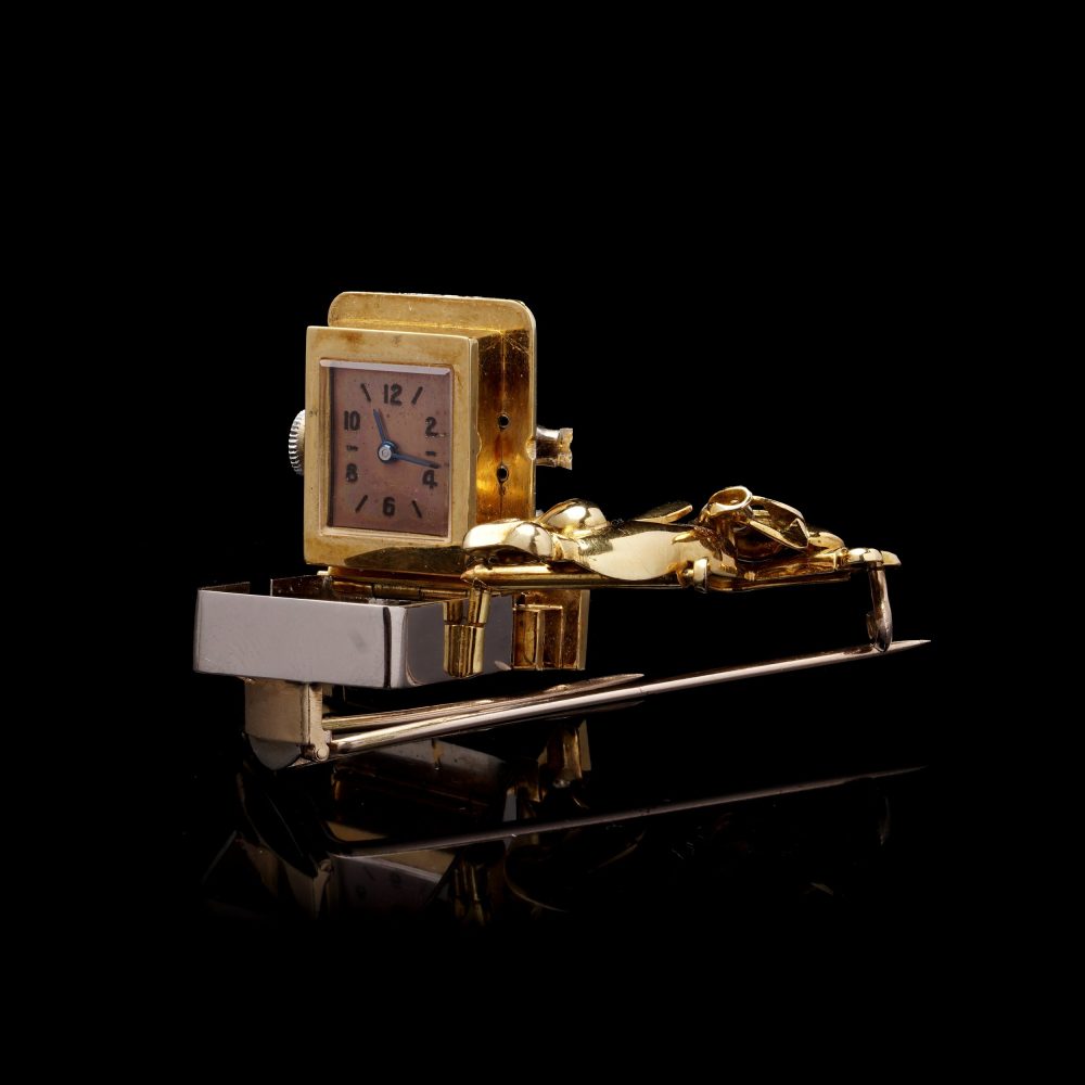 Vintage gold brooch/watch set with gemstones.