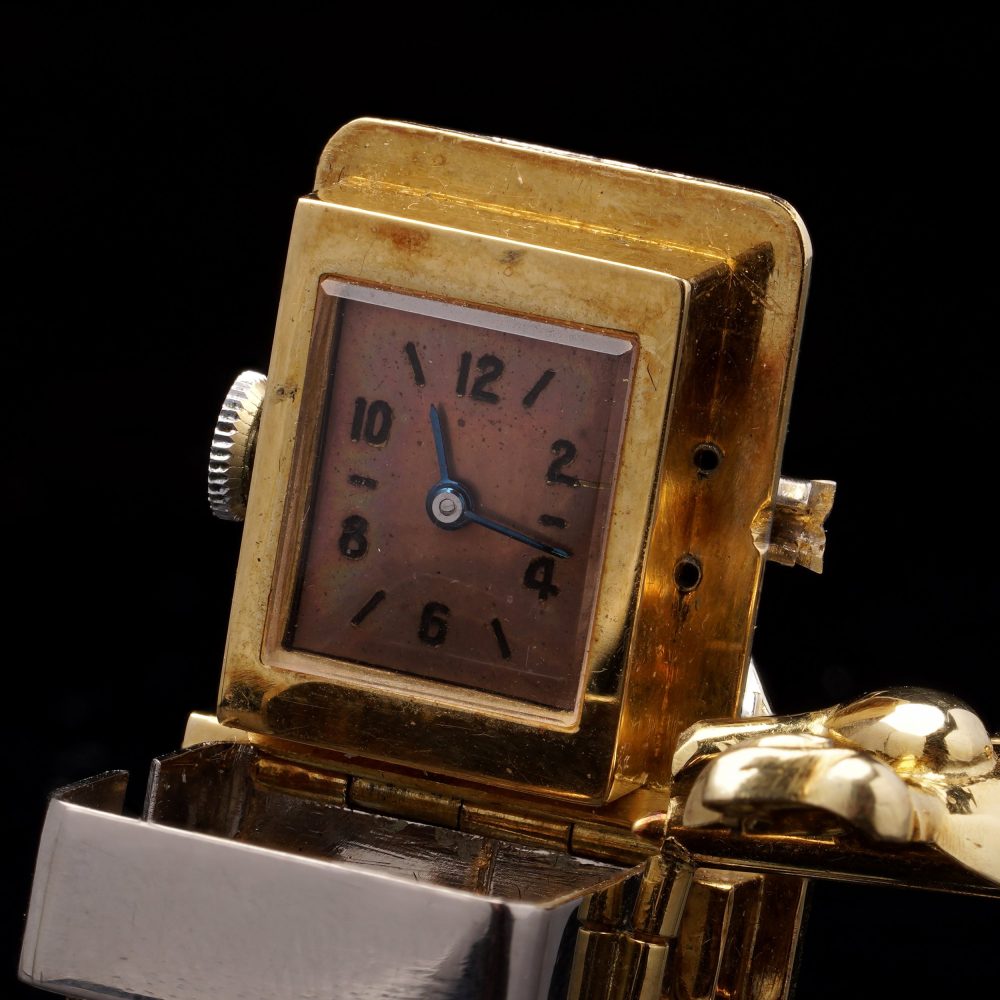 Vintage gold brooch/watch set with gemstones.