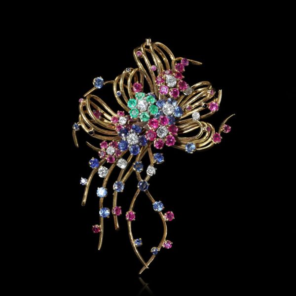 Vintage multi gemstone brooch in gold.