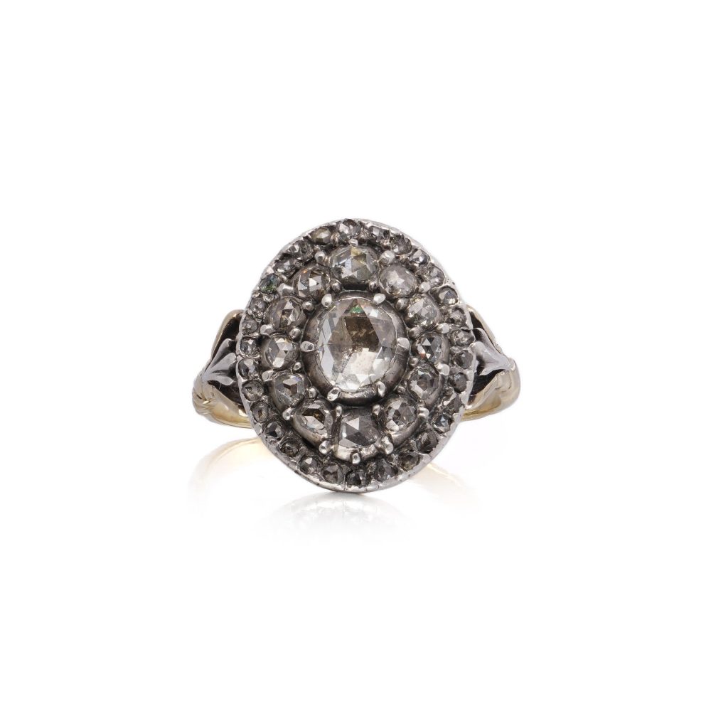 Antique diamond cluster ring in gold and silver.