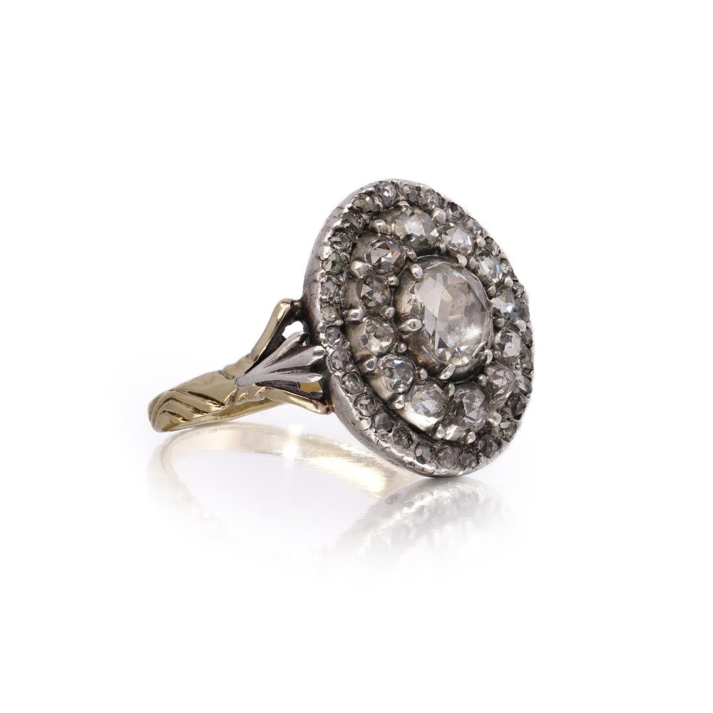Antique diamond cluster ring in gold and silver.