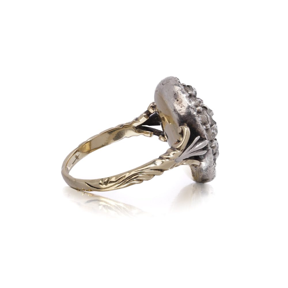 Antique diamond cluster ring in gold and silver.